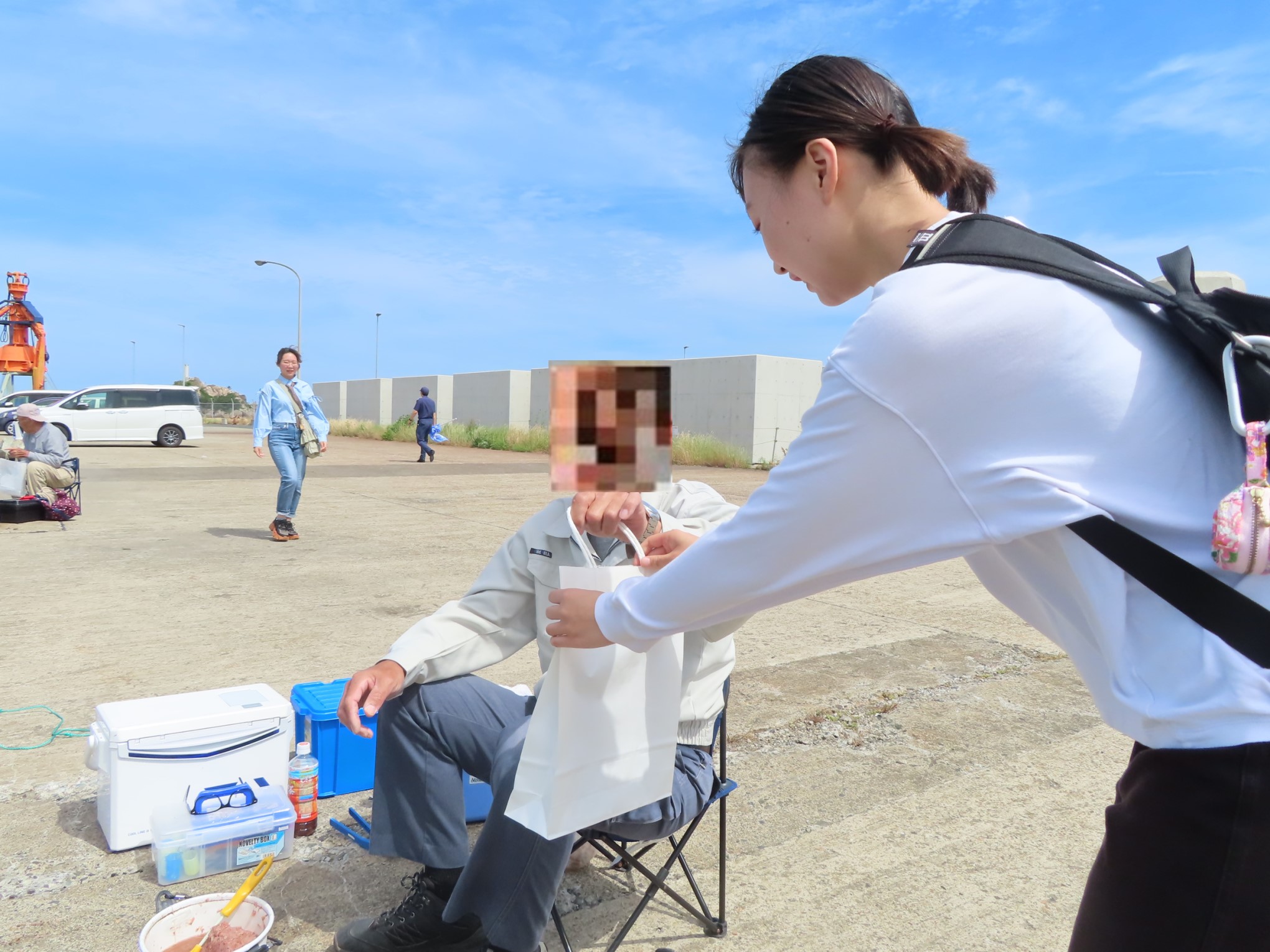 釣り客に啓発物品を配布する公立環境大学の生徒達の画像1