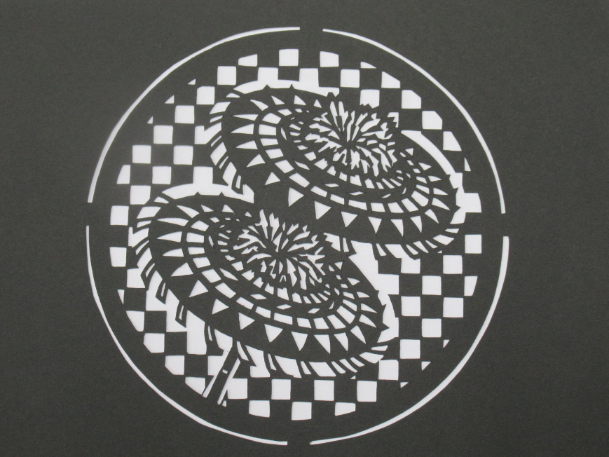 しゃんしゃん傘のデザインマンホールの切り絵の画像