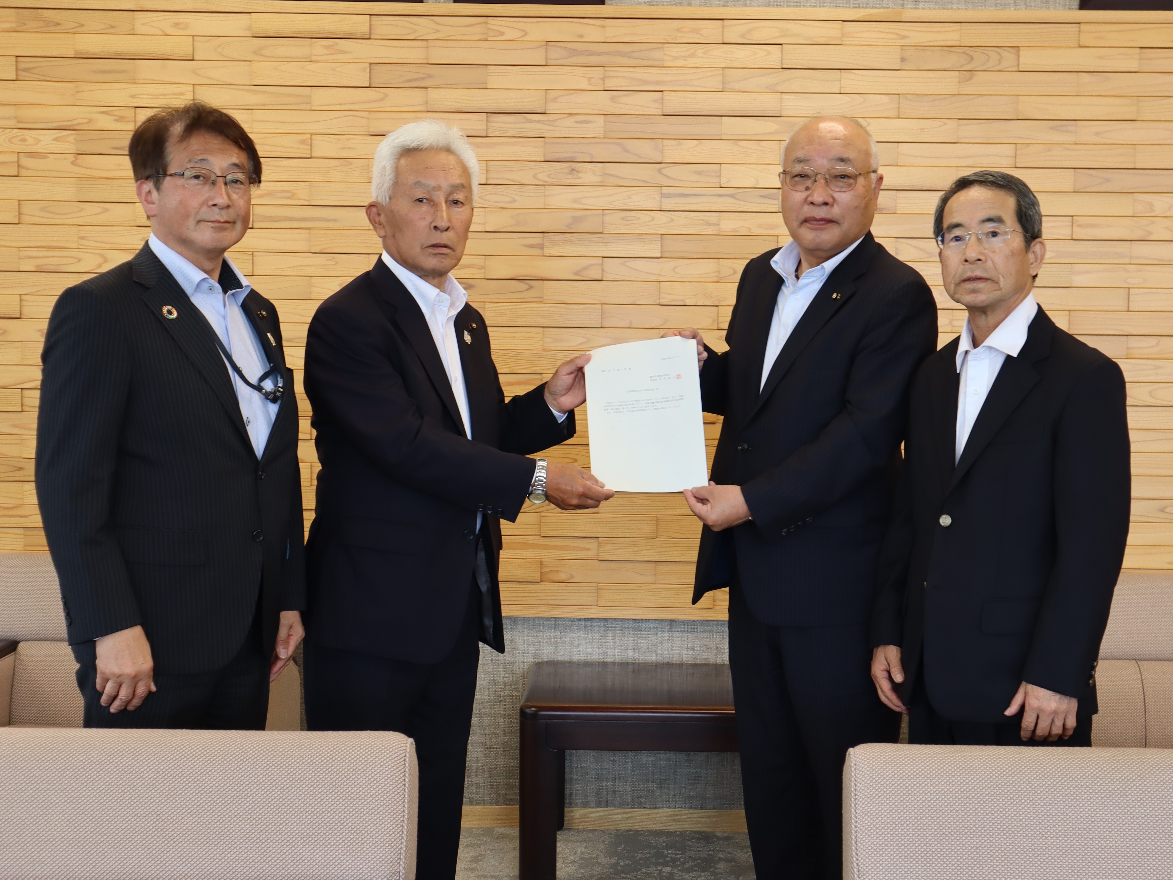 寺坂委員長から西村議長に提言書が手渡される様子の画像