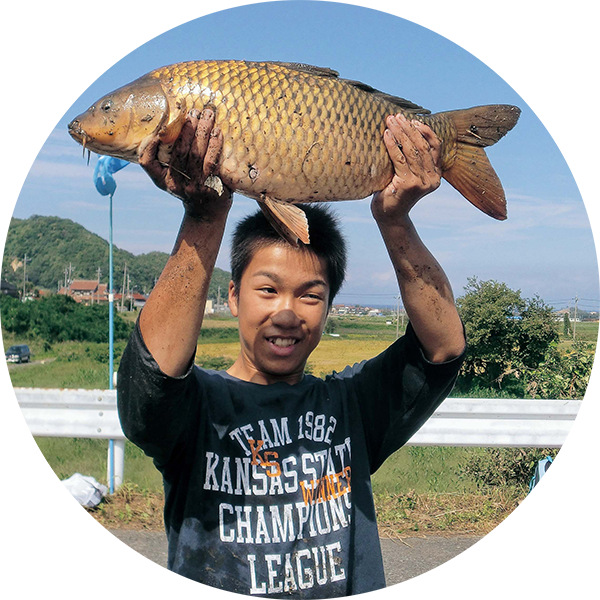 大きな魚を掲げて